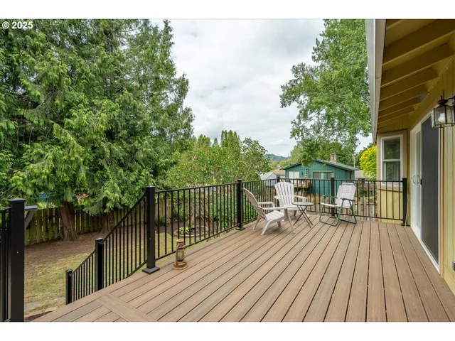 a view of backyard with deck and wooden floor