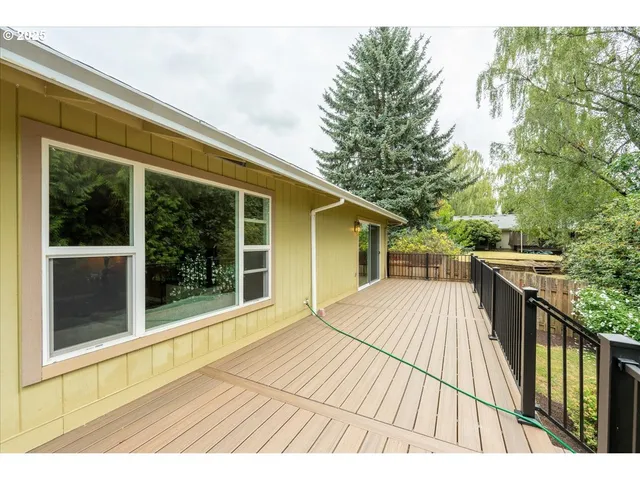 a view of balcony with wooden floor and fence