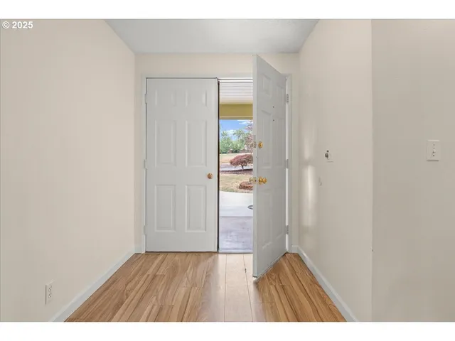 a view of an empty room and wooden floor
