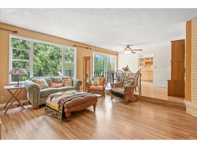 a bedroom with furniture and a large window