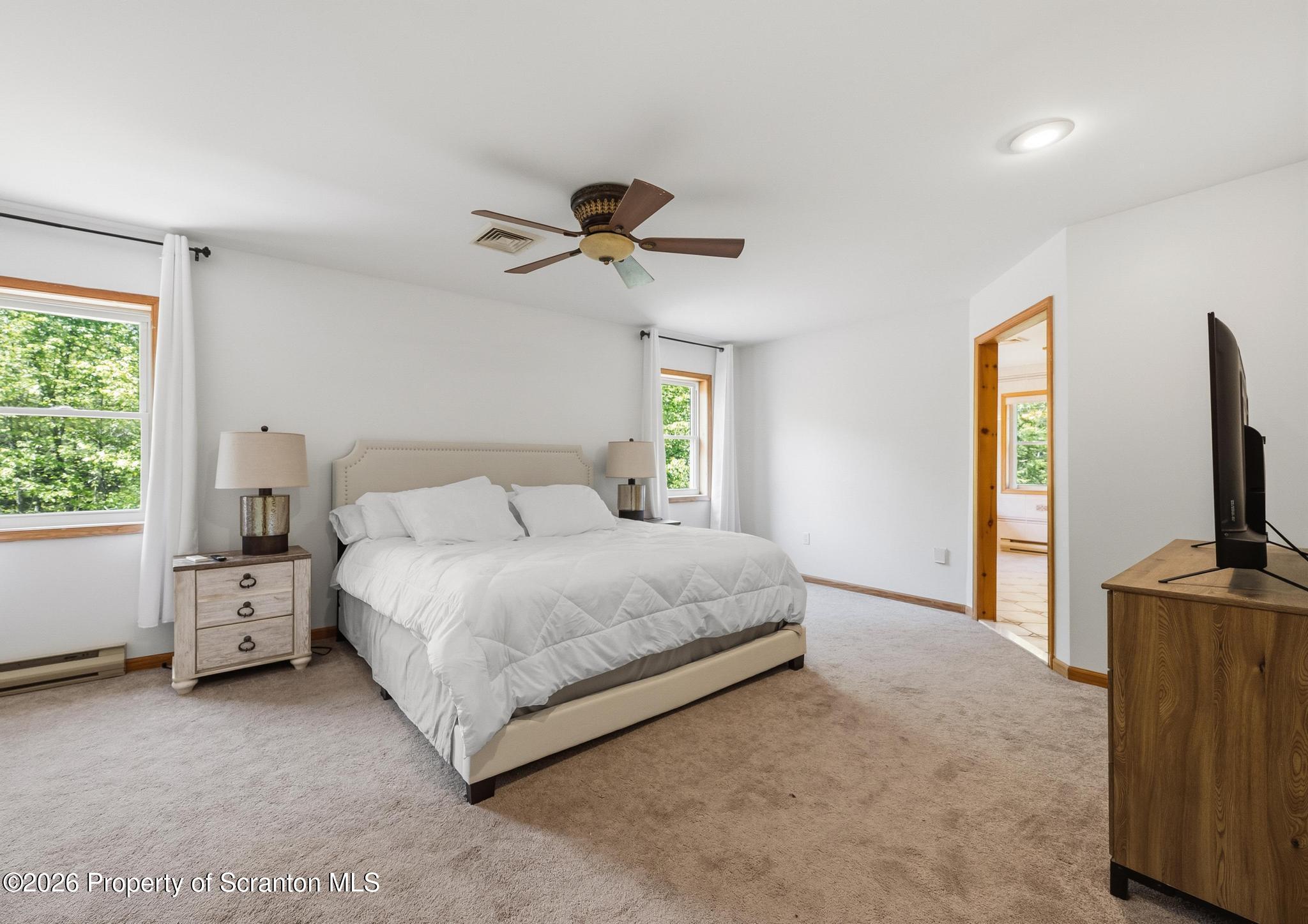 58 Bender Road Gouldsboro, PA 18424 - Photo 19 of 55 a spacious bedroom with a bed and a flat screen tv