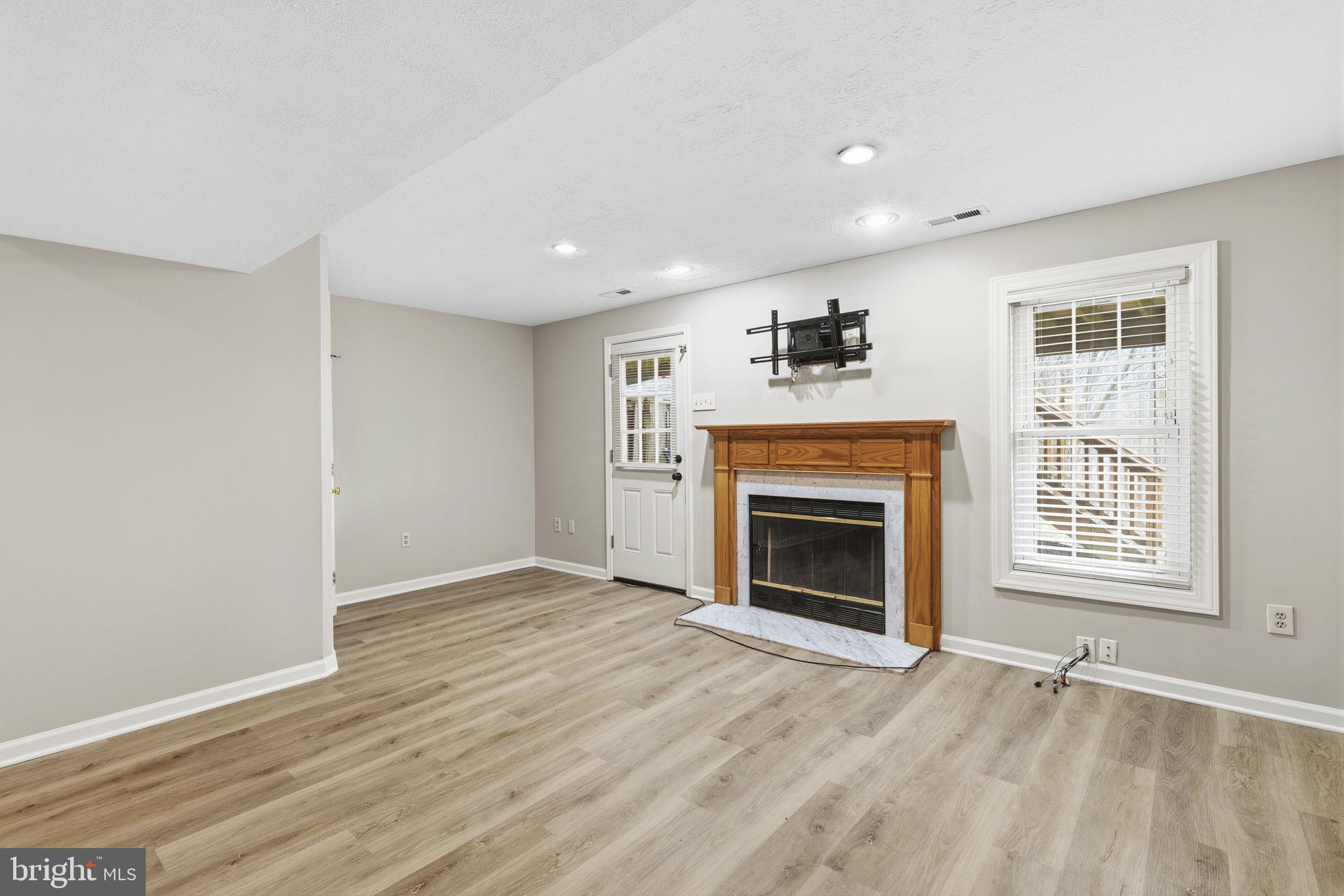 3172 Hidden Ridge Terrace Abingdon, MD 21009 - Photo 22 of 34 an empty room with windows and fireplace