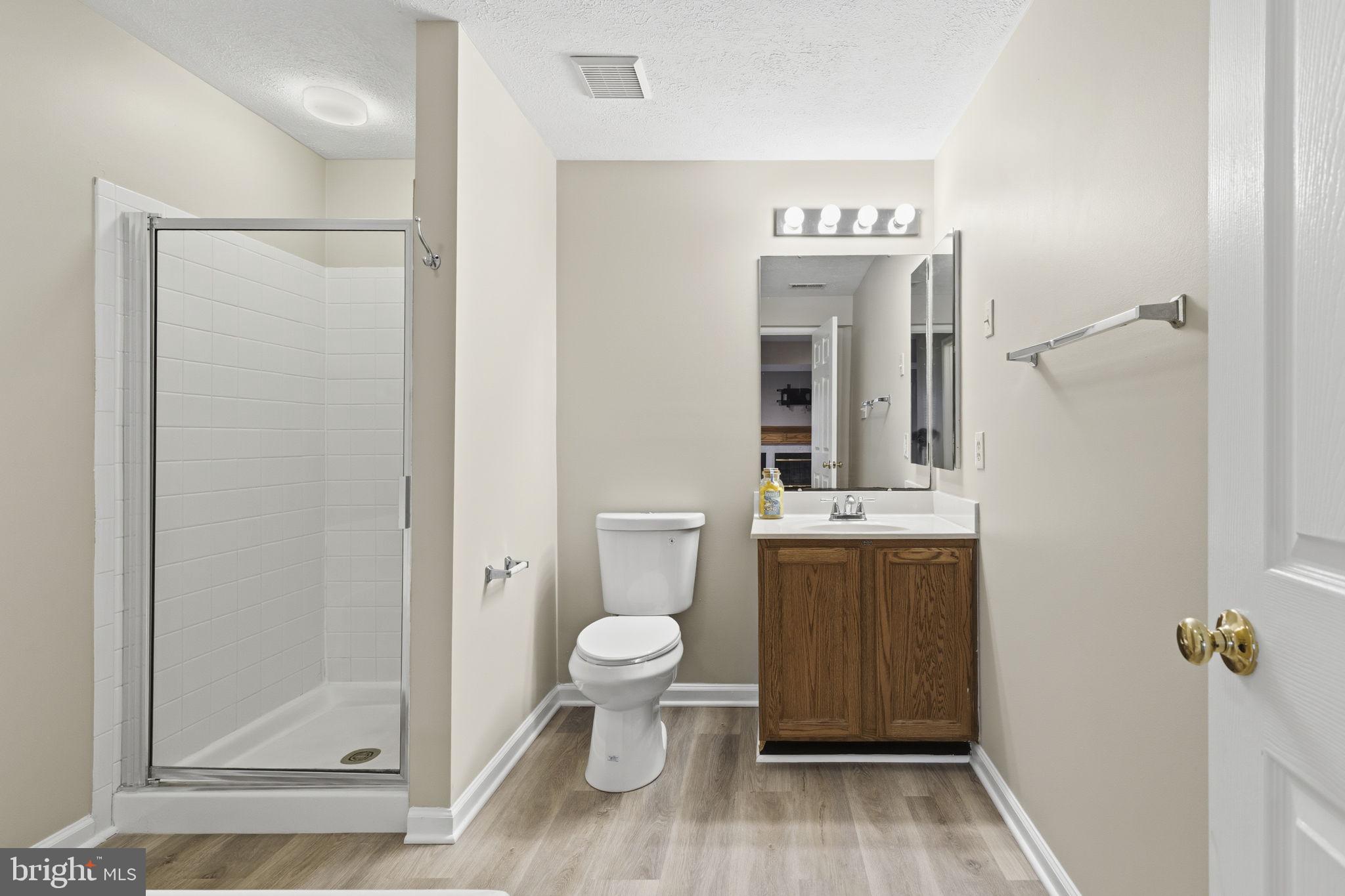 3172 Hidden Ridge Terrace Abingdon, MD 21009 - Photo 25 of 34 a bathroom with a toilet a sink and shower