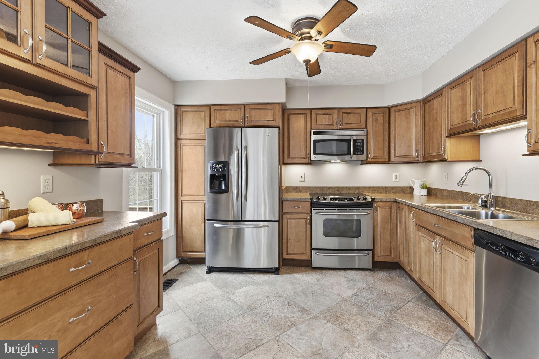 3172 Hidden Ridge Terrace Abingdon, MD 21009 - Photo 8 of 34 a kitchen with stainless steel appliances granite countertop a refrigerator a stove a sink and a microwave