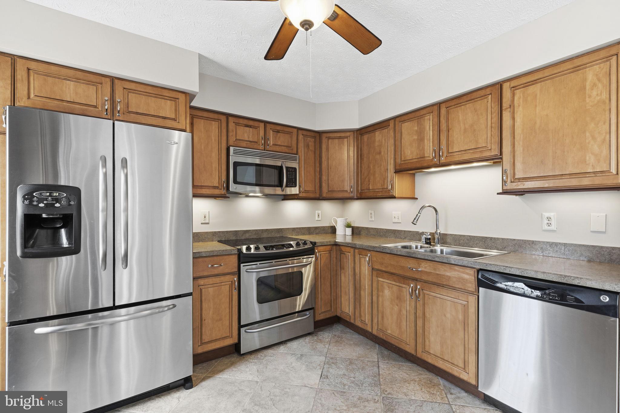 3172 Hidden Ridge Terrace Abingdon, MD 21009 - Photo 9 of 34 a kitchen with stainless steel appliances granite countertop a refrigerator sink and stove