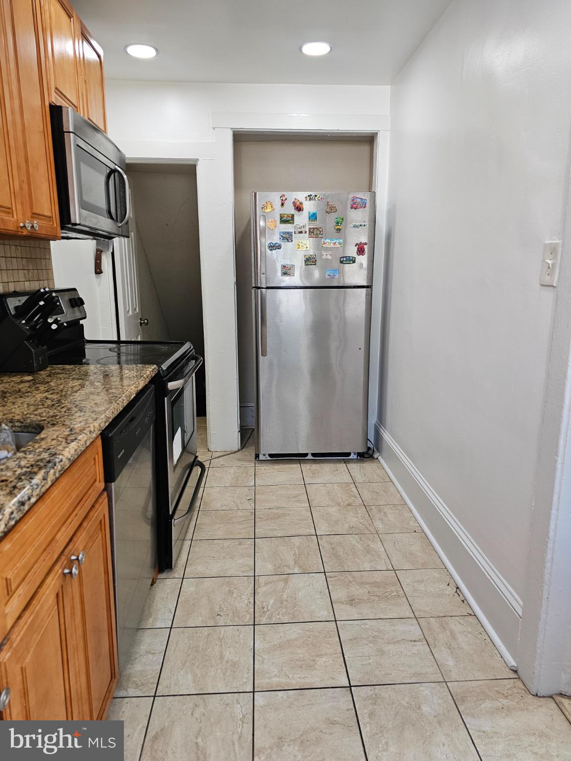 40 North Penn Street Aldan, PA 19018 - Photo 5 of 21 a kitchen with stainless steel appliances granite countertop a refrigerator stove and sink