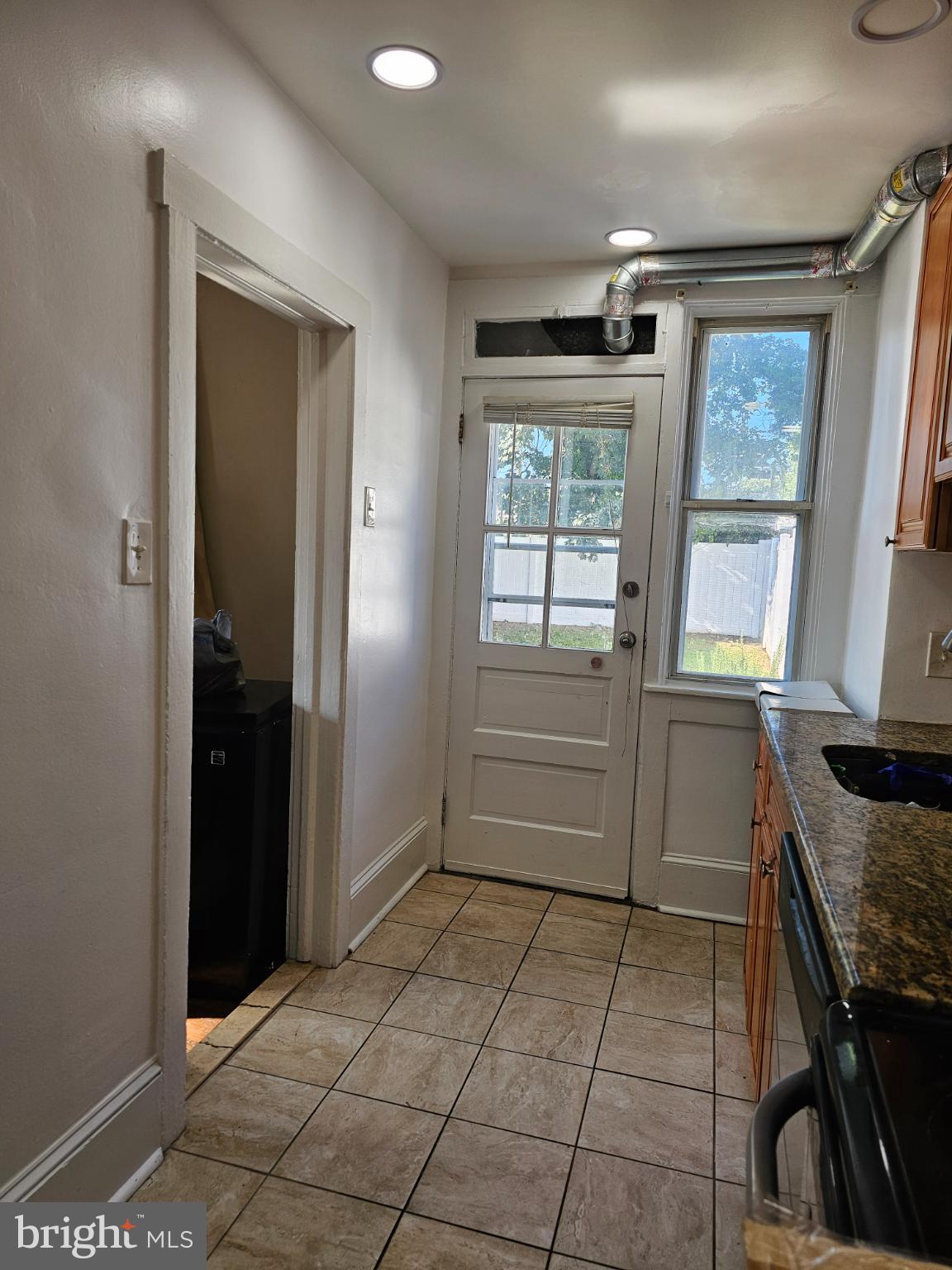 40 North Penn Street Aldan, PA 19018 - Photo 6 of 21 a kitchen with granite countertop a refrigerator and a stove