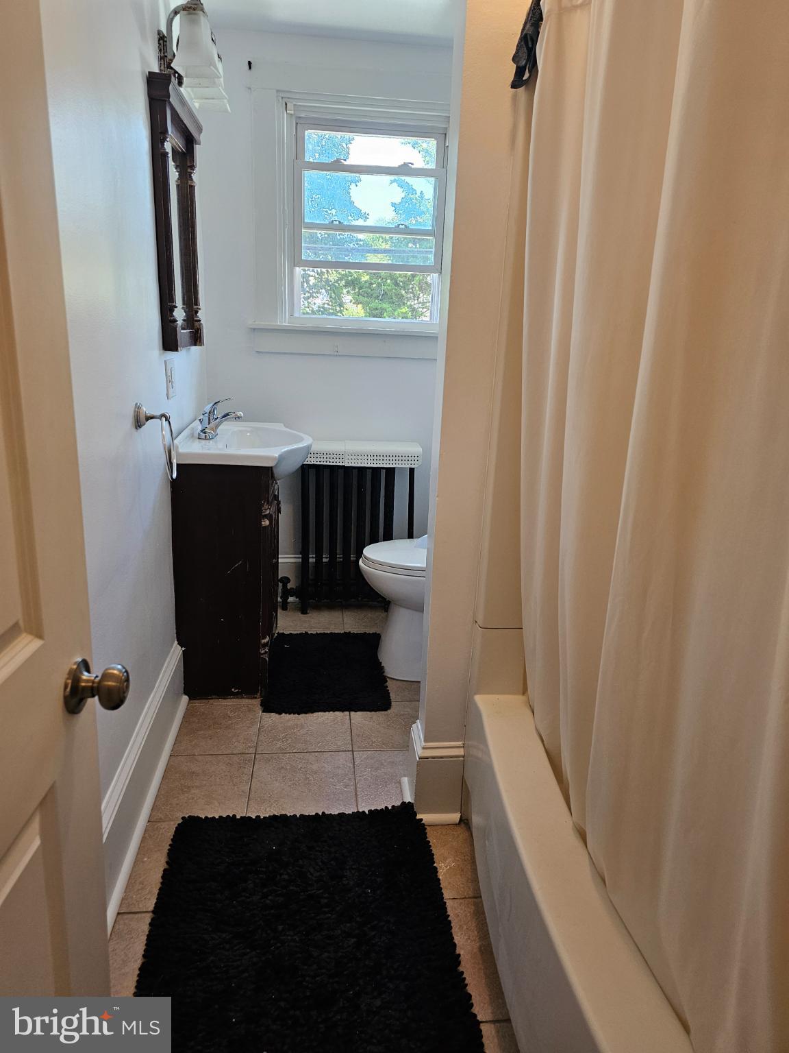 40 North Penn Street Aldan, PA 19018 - Photo 9 of 21 a bathroom with a sink and a mirror