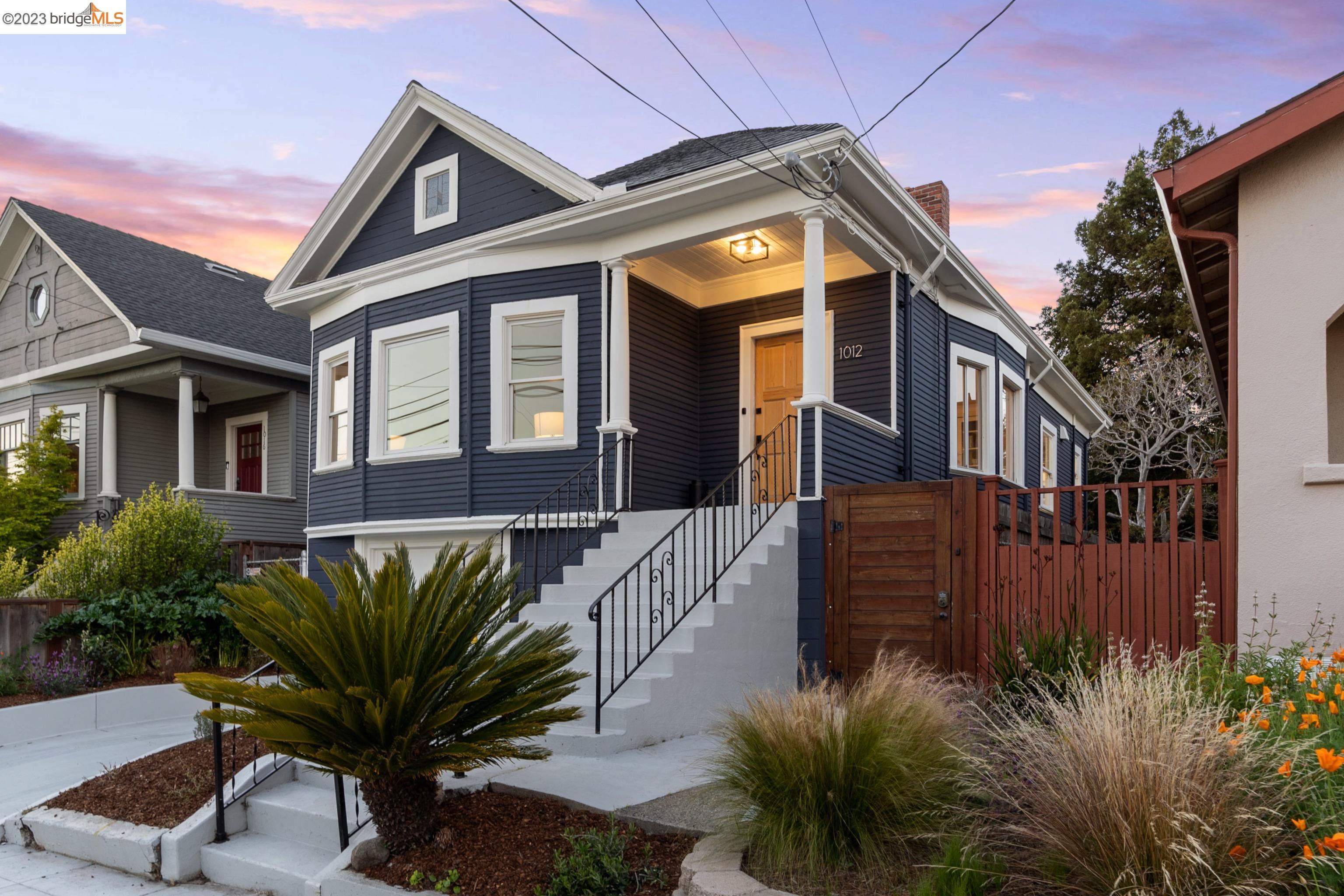 a front view of a house with a garden