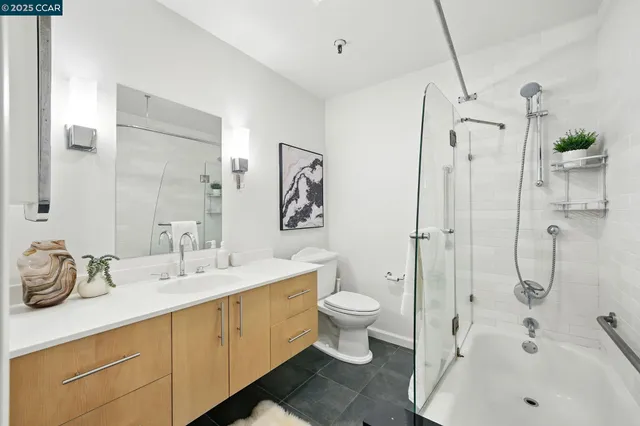 a bathroom with a double vanity sink toilet and shower
