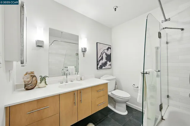 a bathroom with a toilet a sink and a mirror