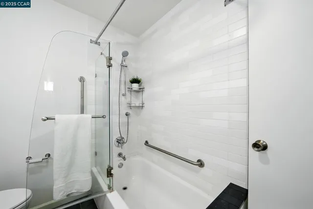 a bathroom with a bathtub and a shower