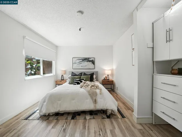 a bedroom with a bed and wooden floor