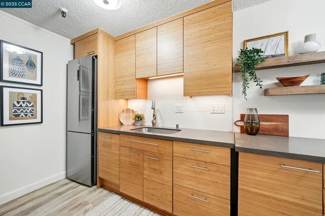 a kitchen with stainless steel appliances granite countertop a refrigerator and a sink