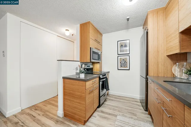 a kitchen with stainless steel appliances granite countertop a stove and a refrigerator