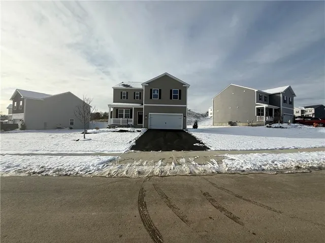 a view of a house with a snow in the road