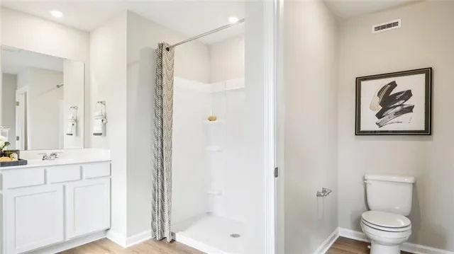a bathroom with a shower toilet and sink