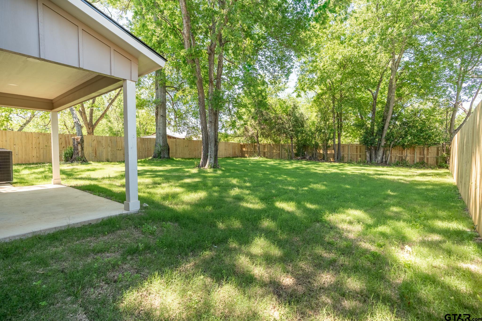 233 Harrison Street Longview, TX 75601 - Photo 35 of 44 a view of green field with trees in the background