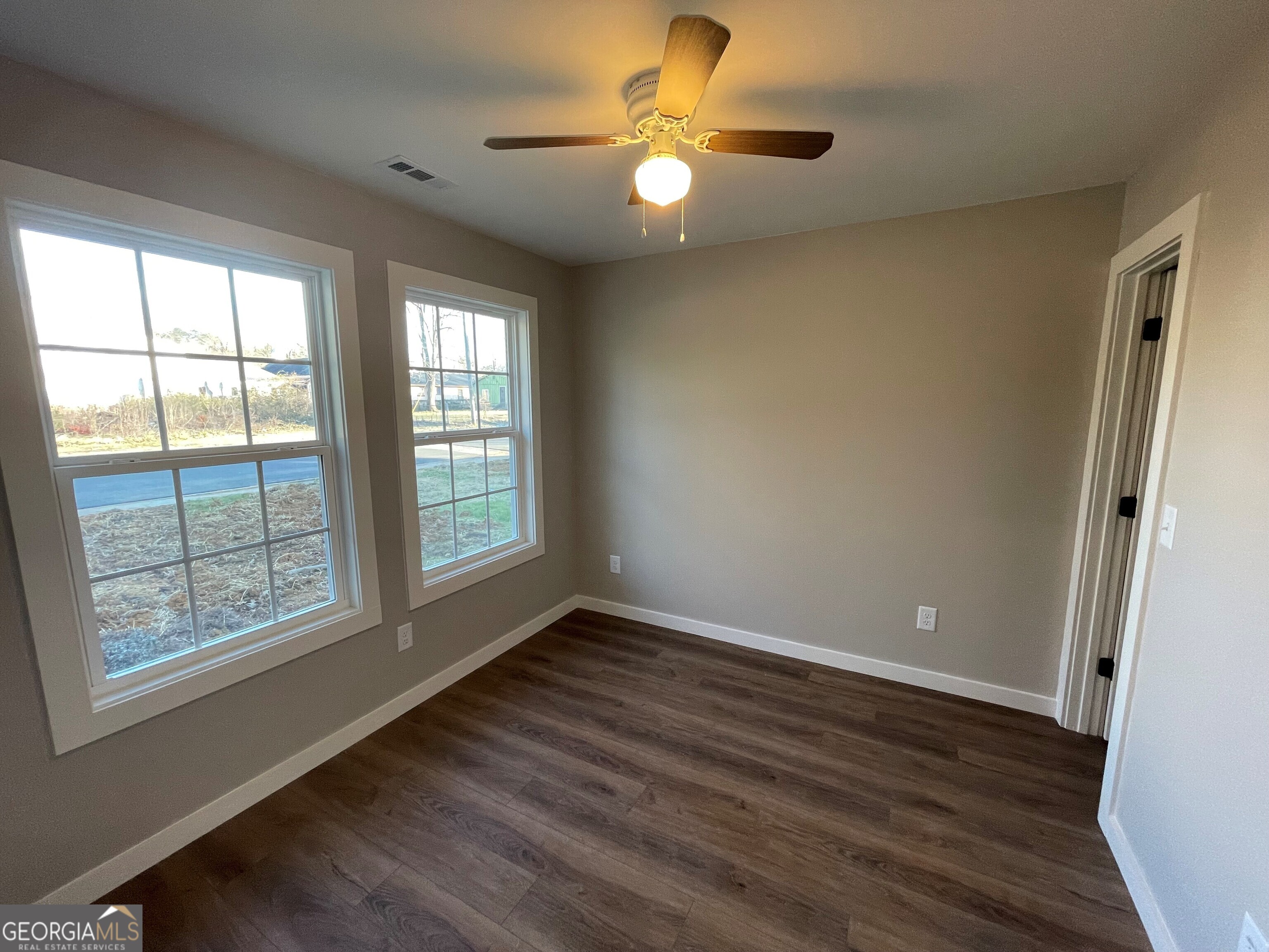 410 Hardy Avenue Southwest Rome, GA 30161 - Photo 11 of 36 a view of an empty room with a window and wooden floor
