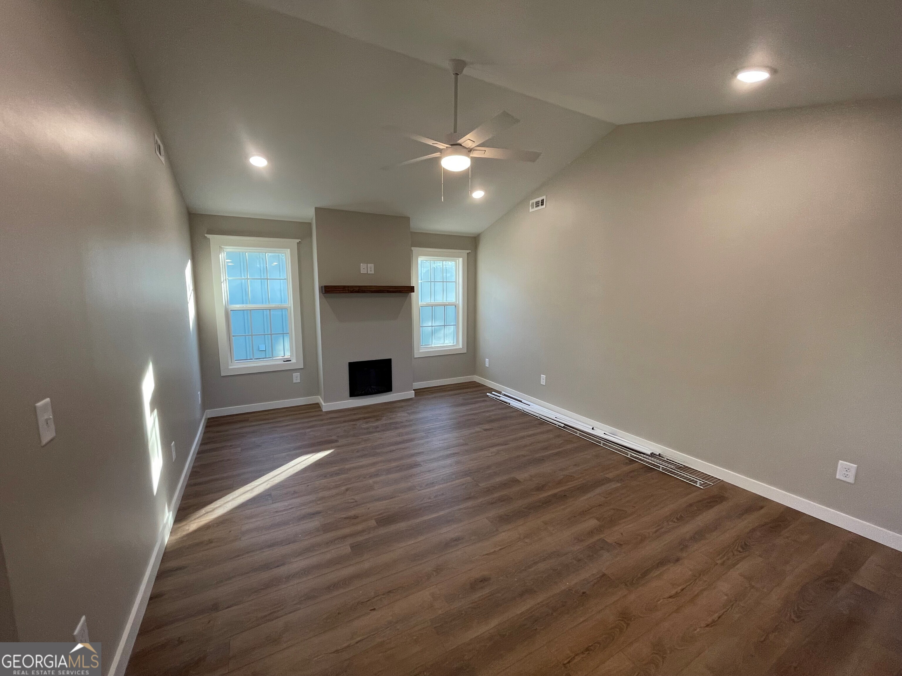 410 Hardy Avenue Southwest Rome, GA 30161 - Photo 14 of 36 an empty room with wooden floor and fireplace