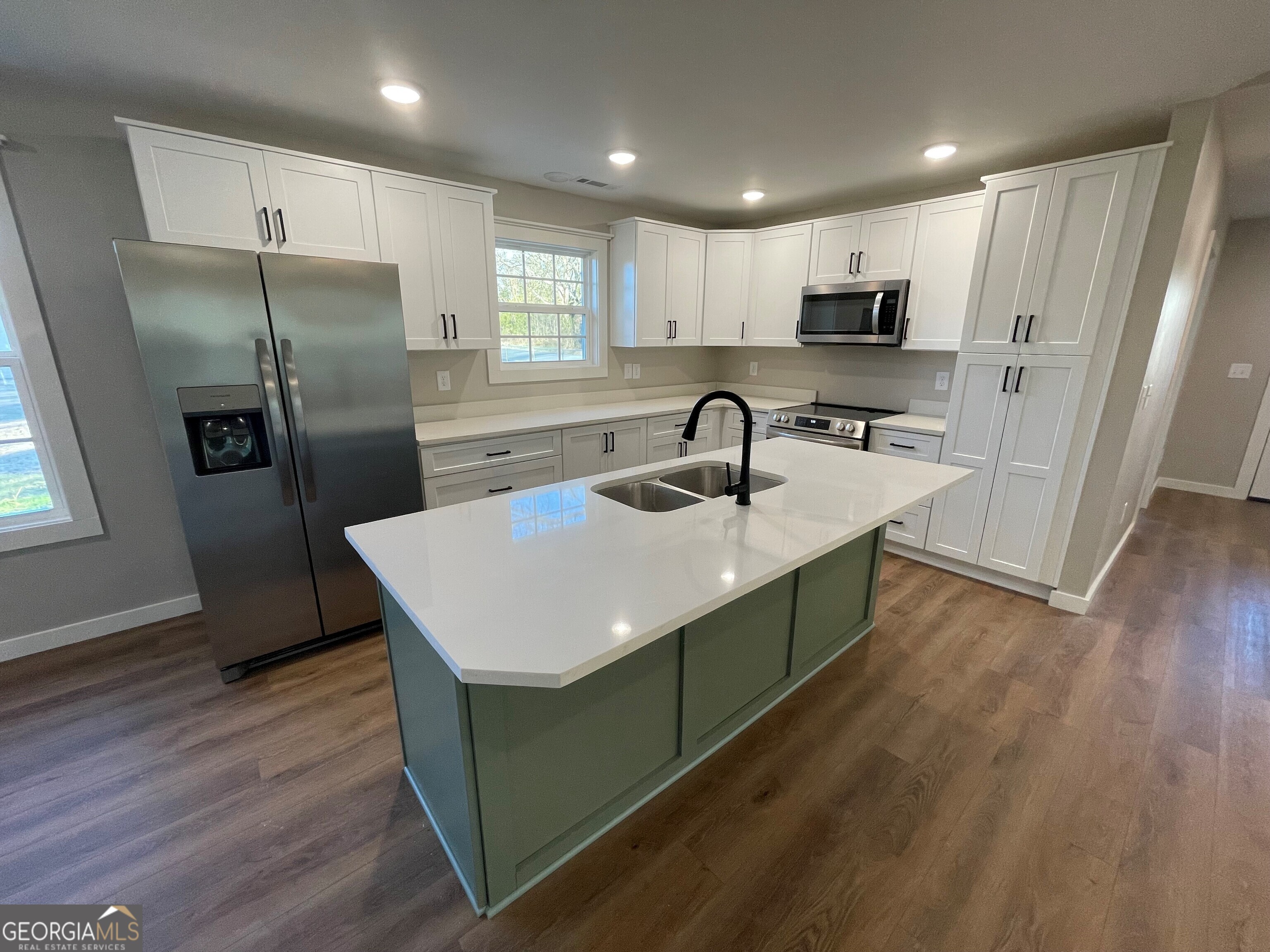 410 Hardy Avenue Southwest Rome, GA 30161 - Photo 18 of 36 a kitchen with stainless steel appliances a sink a refrigerator and wooden floor