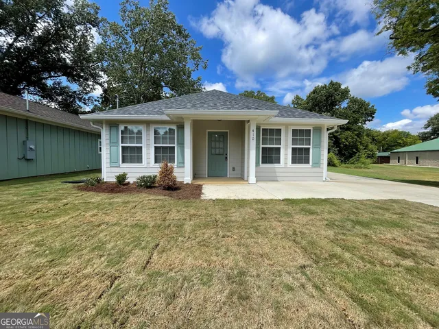 a front view of a house with garden