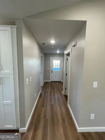 a view of hallway with wooden floor