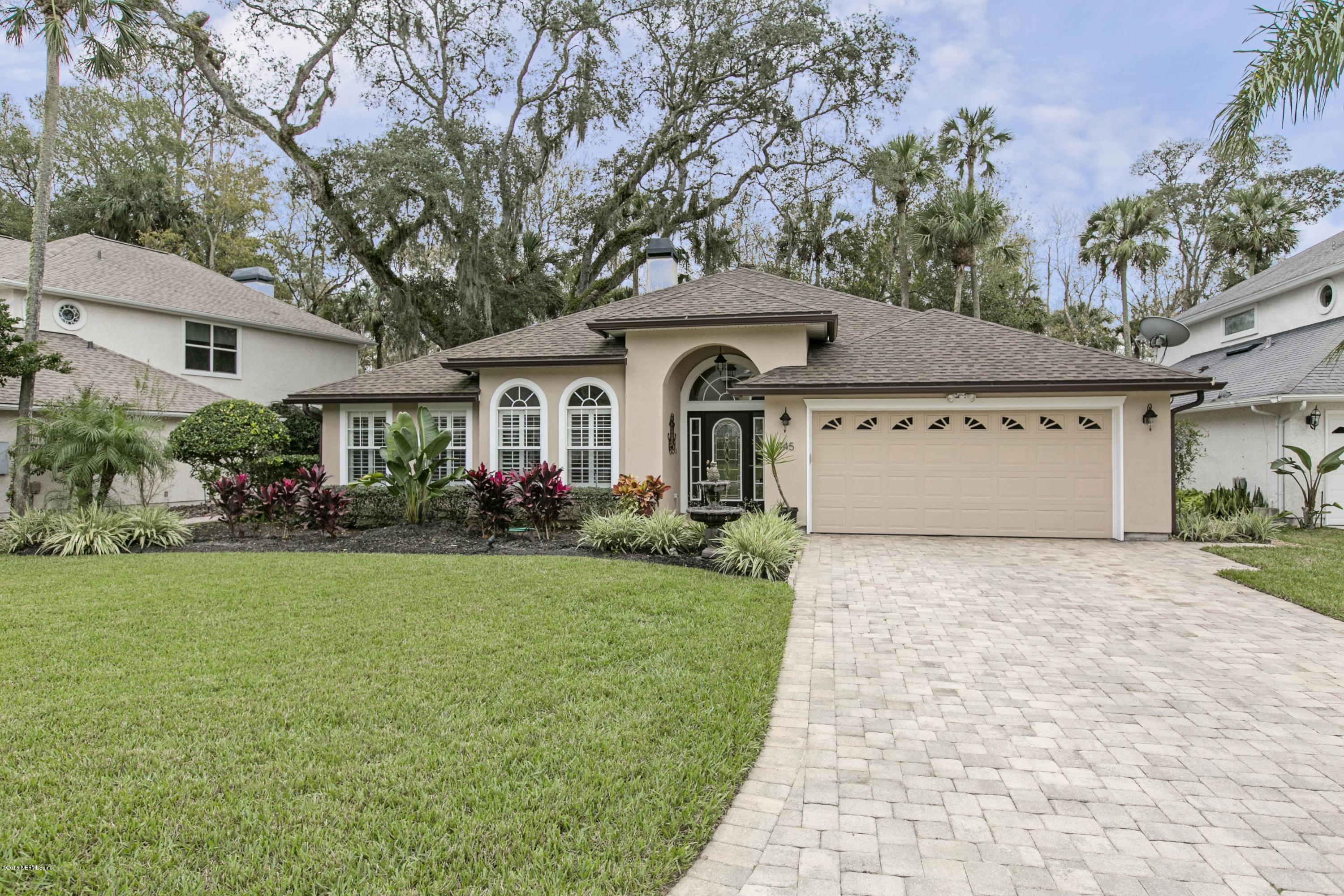 445 Big Tree Road Ponte Vedra Beach, FL 32082 - Photo 1 of 23 a front view of a house with a garden and trees