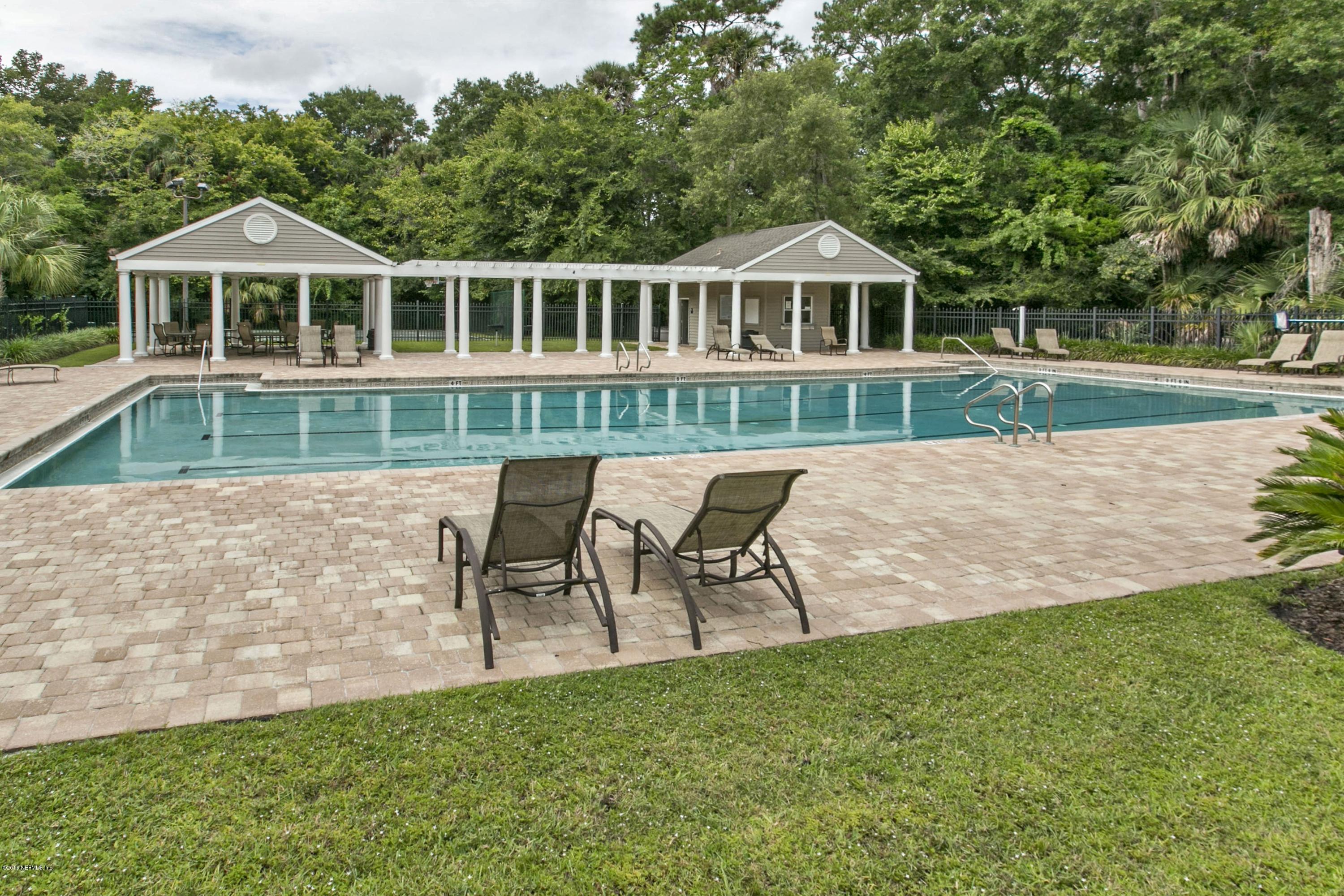 445 Big Tree Road Ponte Vedra Beach, FL 32082 - Photo 23 of 23 a front view of a house with a yard table and chairs