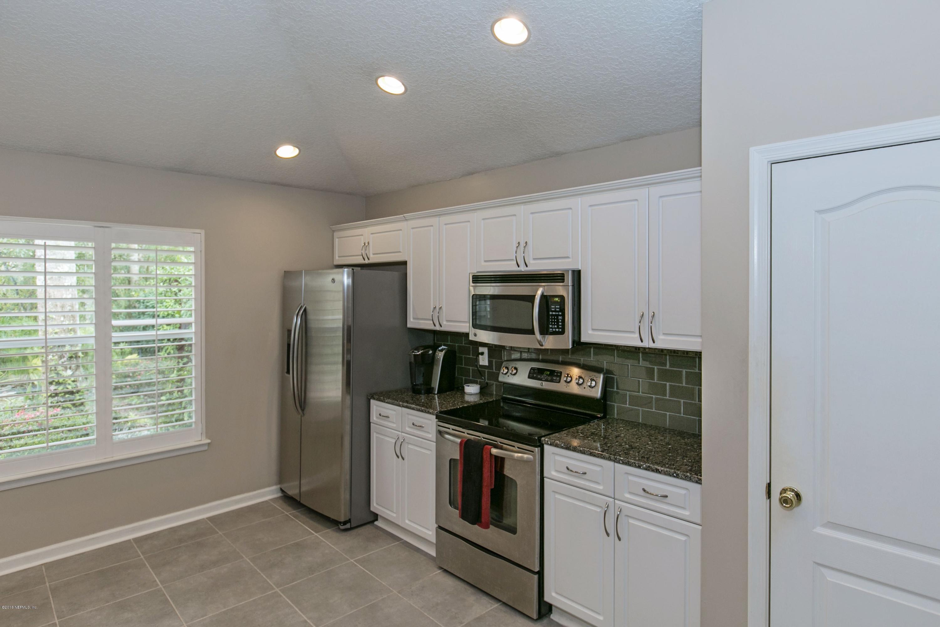 445 Big Tree Road Ponte Vedra Beach, FL 32082 - Photo 7 of 23 a kitchen with stainless steel appliances a stove microwave and refrigerator