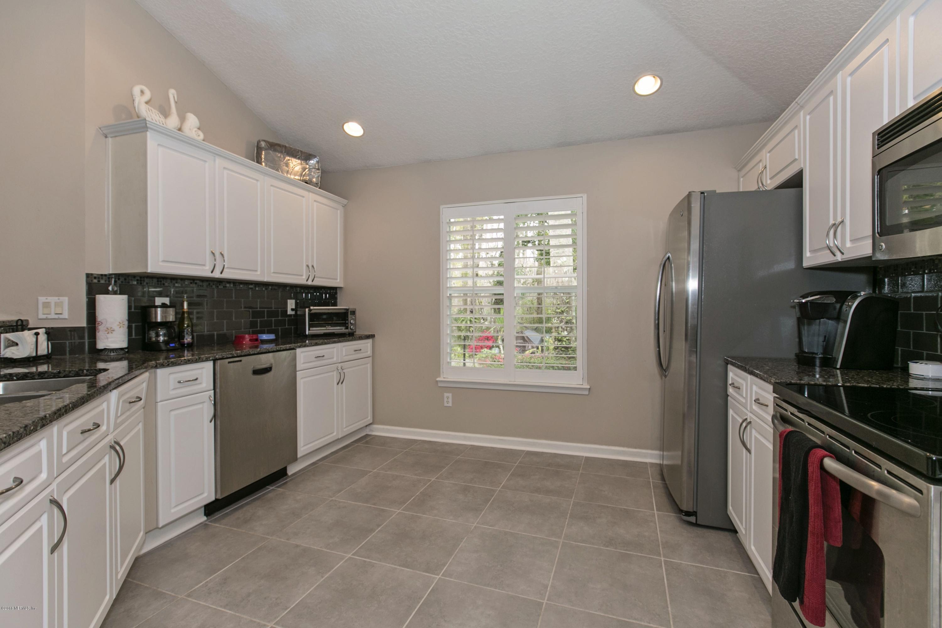 445 Big Tree Road Ponte Vedra Beach, FL 32082 - Photo 8 of 23 a kitchen with a sink stove and cabinets