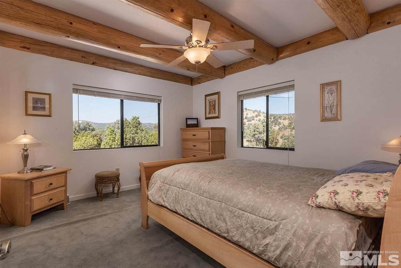 2441 Enterprise Road Reno, NV 89521 - Photo 11 of 25 a bedroom with a bed and a window