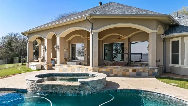 a view of a house with swimming pool and sitting area