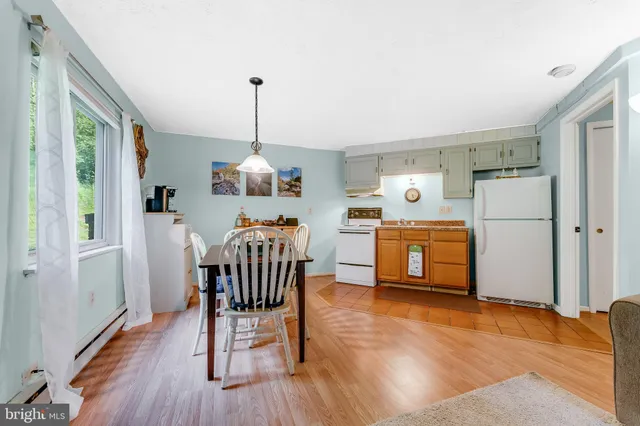 a dining room with furniture a chandelier and wooden floor