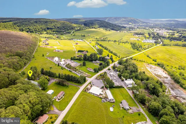 an aerial view of a swimming pool with a yard