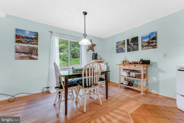 a view of a livingroom with furniture window and wooden floor