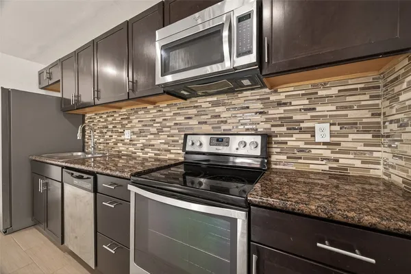 a stove top oven sitting inside of a kitchen