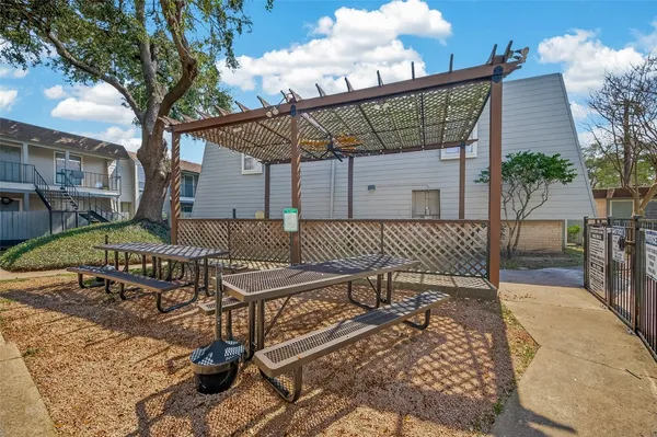 a patio with table and chairs