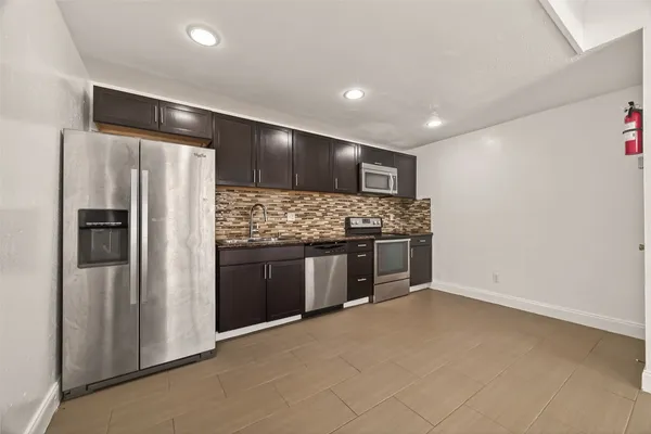 a kitchen with stainless steel appliances a refrigerator and a stove