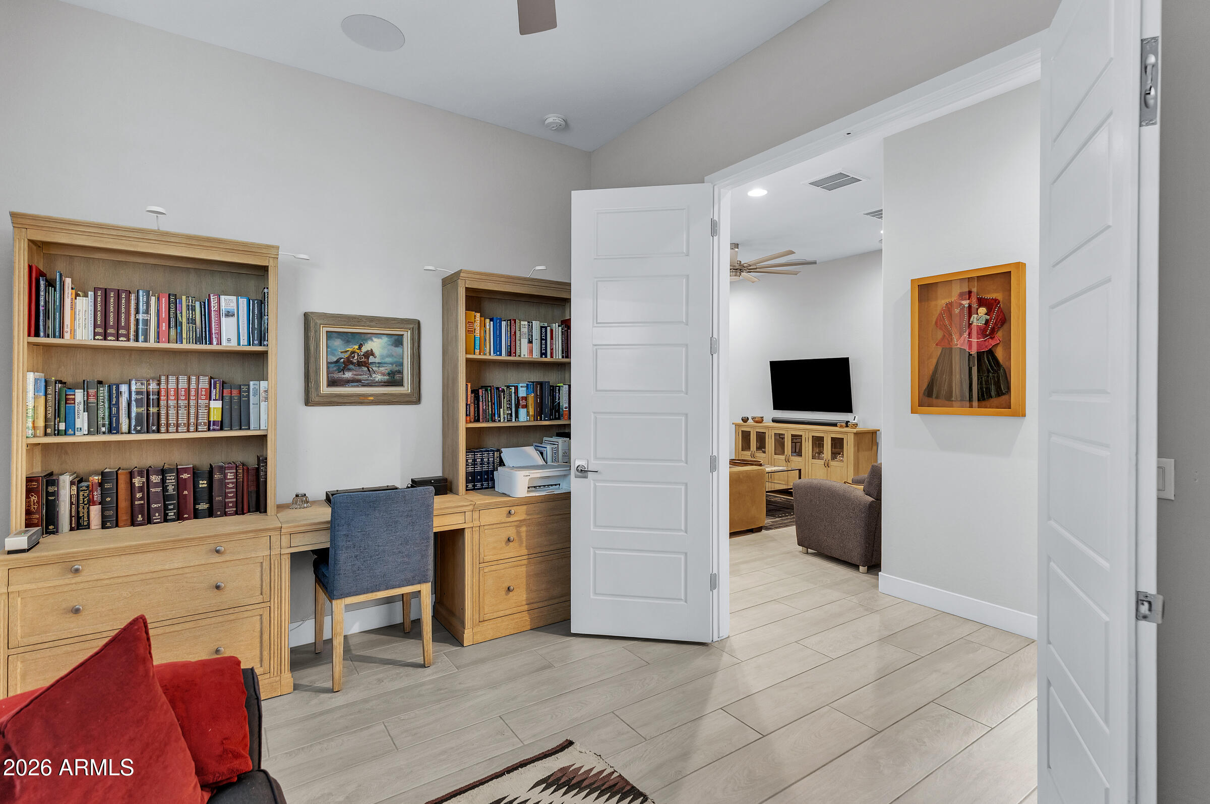 622 West Deer Creek Road Phoenix, AZ 85048 - Photo 20 of 39 a view of a workspace with furniture and bookshelf