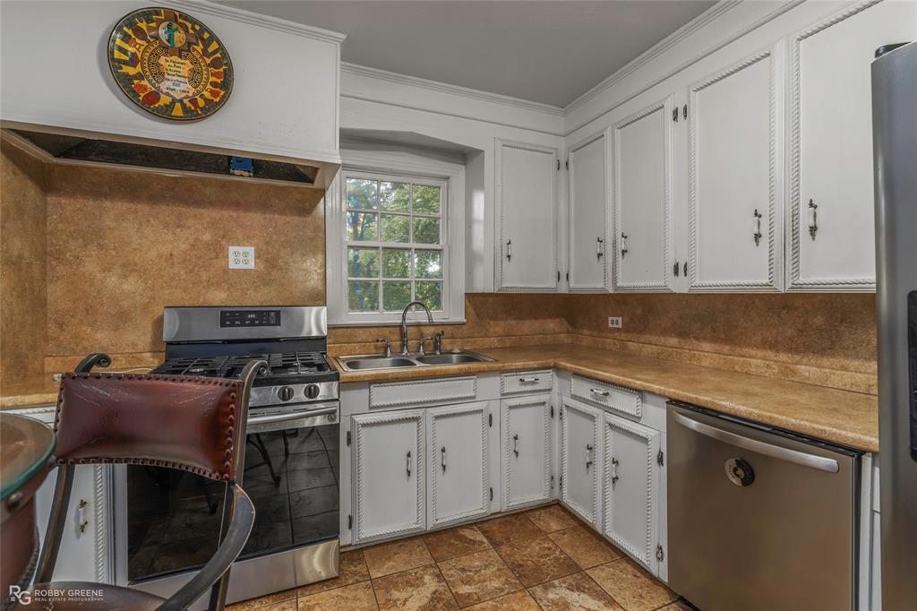 515 Davis Street Minden, LA 71055 - Photo 5 of 28 a kitchen with stainless steel appliances granite countertop a stove a sink and a microwave