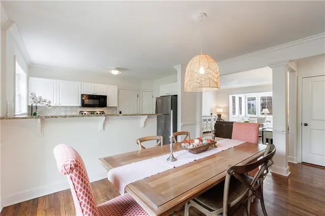a view of a dining room with furniture window and wooden floor