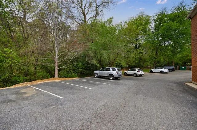 an aerial view of a house with a yard and lake view