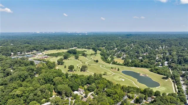 an aerial view of residential houses with outdoor space and swimming pool
