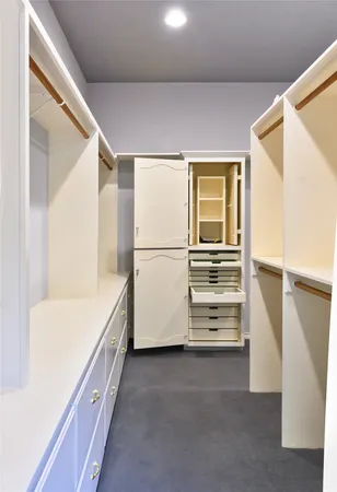 a view of walk in closet with empty racks