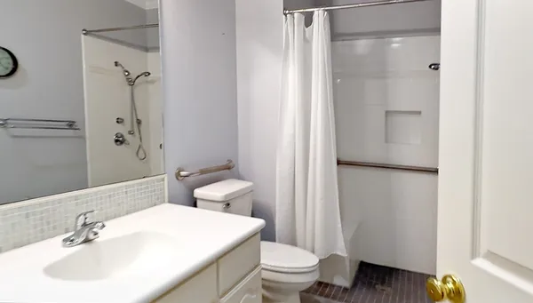 a bathroom with a sink toilet and shower