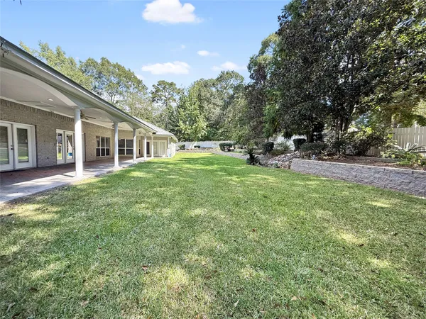 a view of a house with backyard porch and sitting area