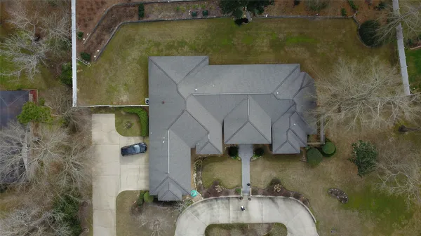 an aerial view of a house with a yard