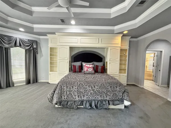 a bedroom with a large bed and a fireplace