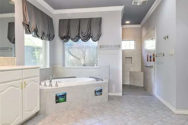 a bathroom with a sink a bathtub and a window